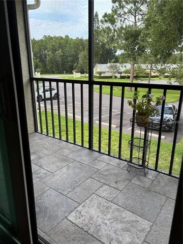 a dining room with furniture water view and a floor to ceiling window
