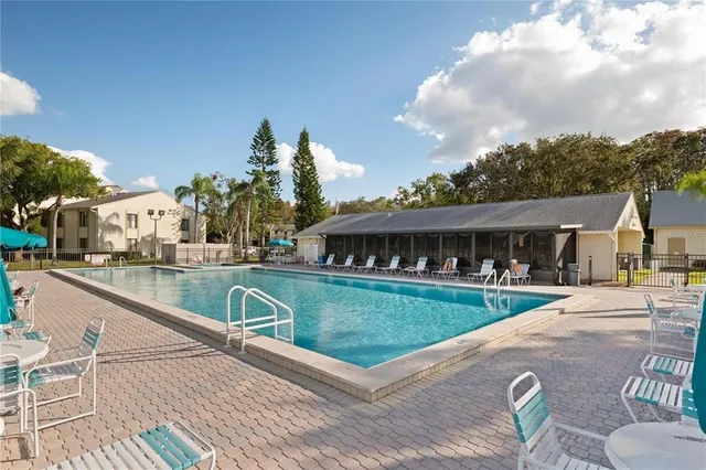 a dining room with furniture water view and a floor to ceiling window