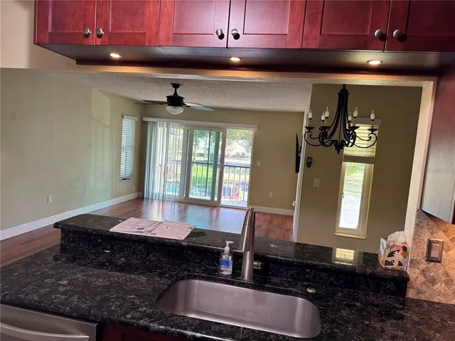 a view of a room with wooden floor and a window