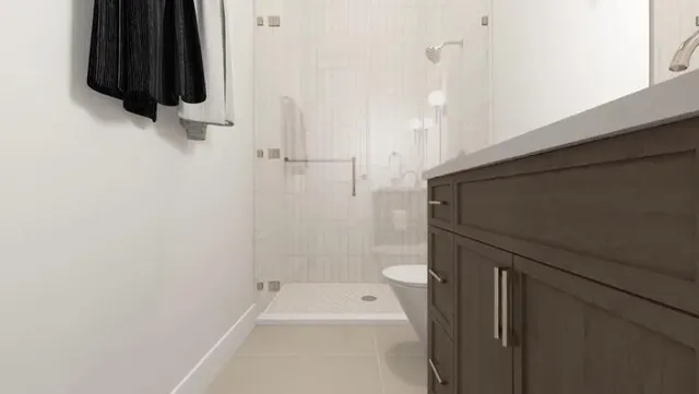 a bathroom with a sink a toilet and shower