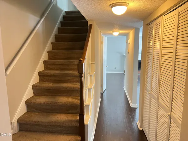 a view of entryway and hall with wooden floor
