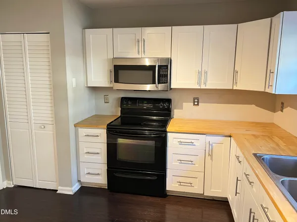 a kitchen with stainless steel appliances granite countertop a stove and a microwave