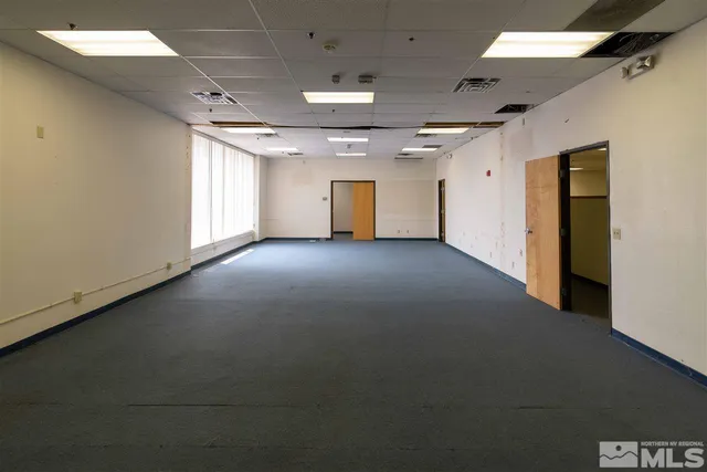 an empty room with windows and closet