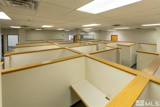 a view of an empty room with kitchen