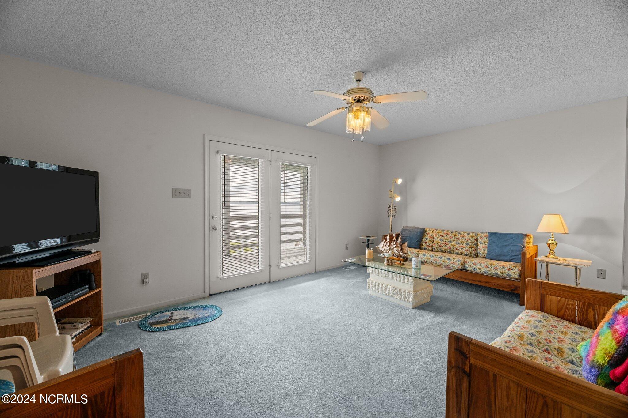 356 Windy Point Road Bayboro, NC 28515 - Photo 9 of 43 Living room opens to covered porch