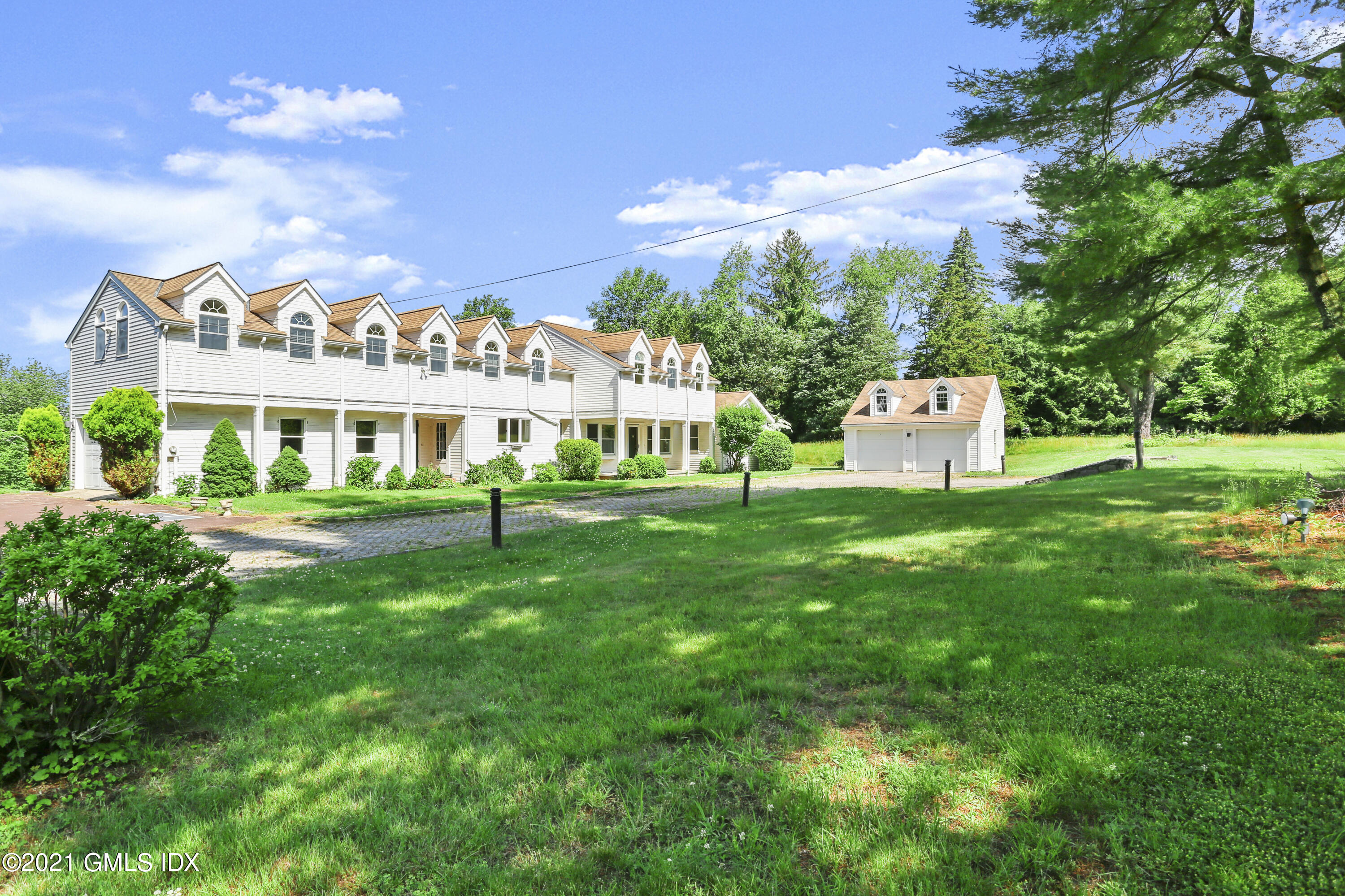 646 Riversville Road Greenwich, CT 06831 - Photo 1 of 3 a view of a house with a big yard