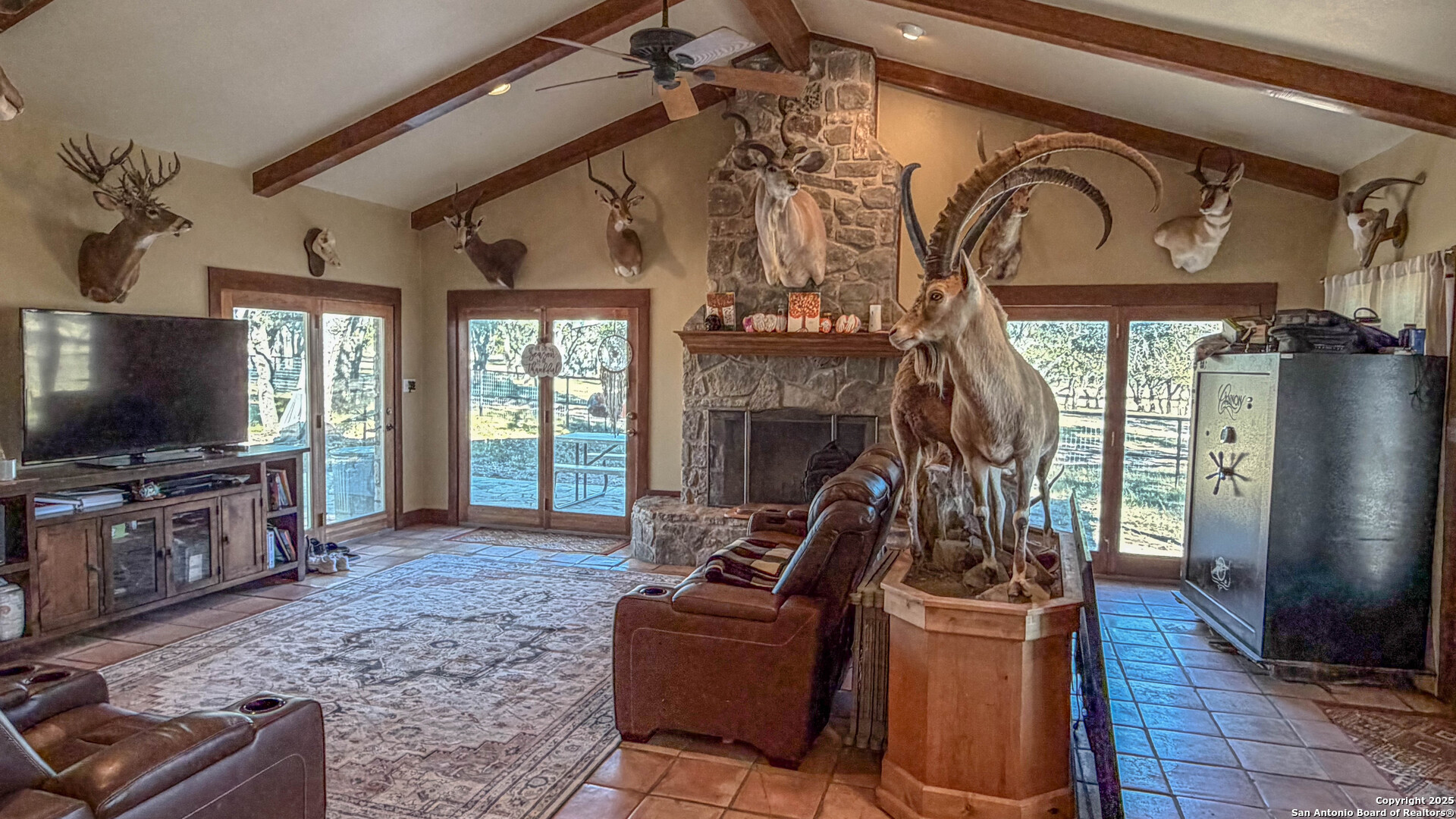 1950 Tolles Road Menard, TX 76859 - Photo 10 of 54 a living room with furniture a flat screen tv and a fireplace