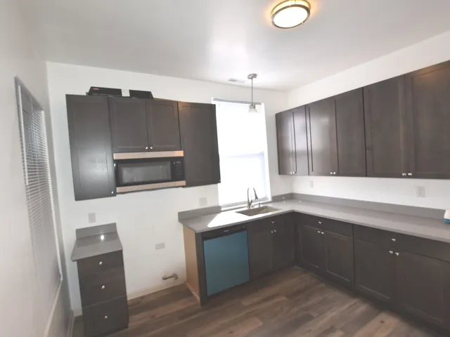 a kitchen with cabinets a sink and appliances