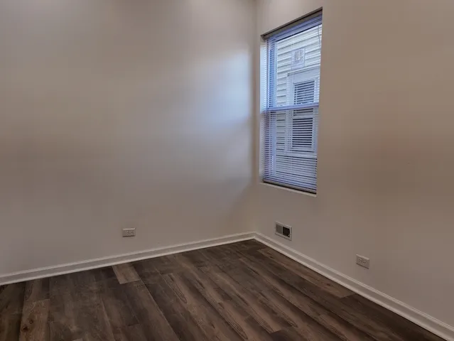 a room with rack on the wall and a window