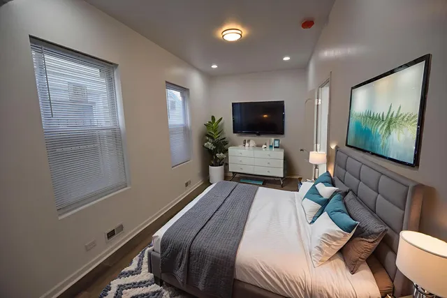 a bedroom with a bed and a flat screen tv