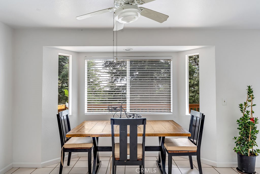 318 Old Toll Road Lake Arrowhead, CA 92352 - Photo 24 of 44 a view of a dining room with furniture window and wooden floor