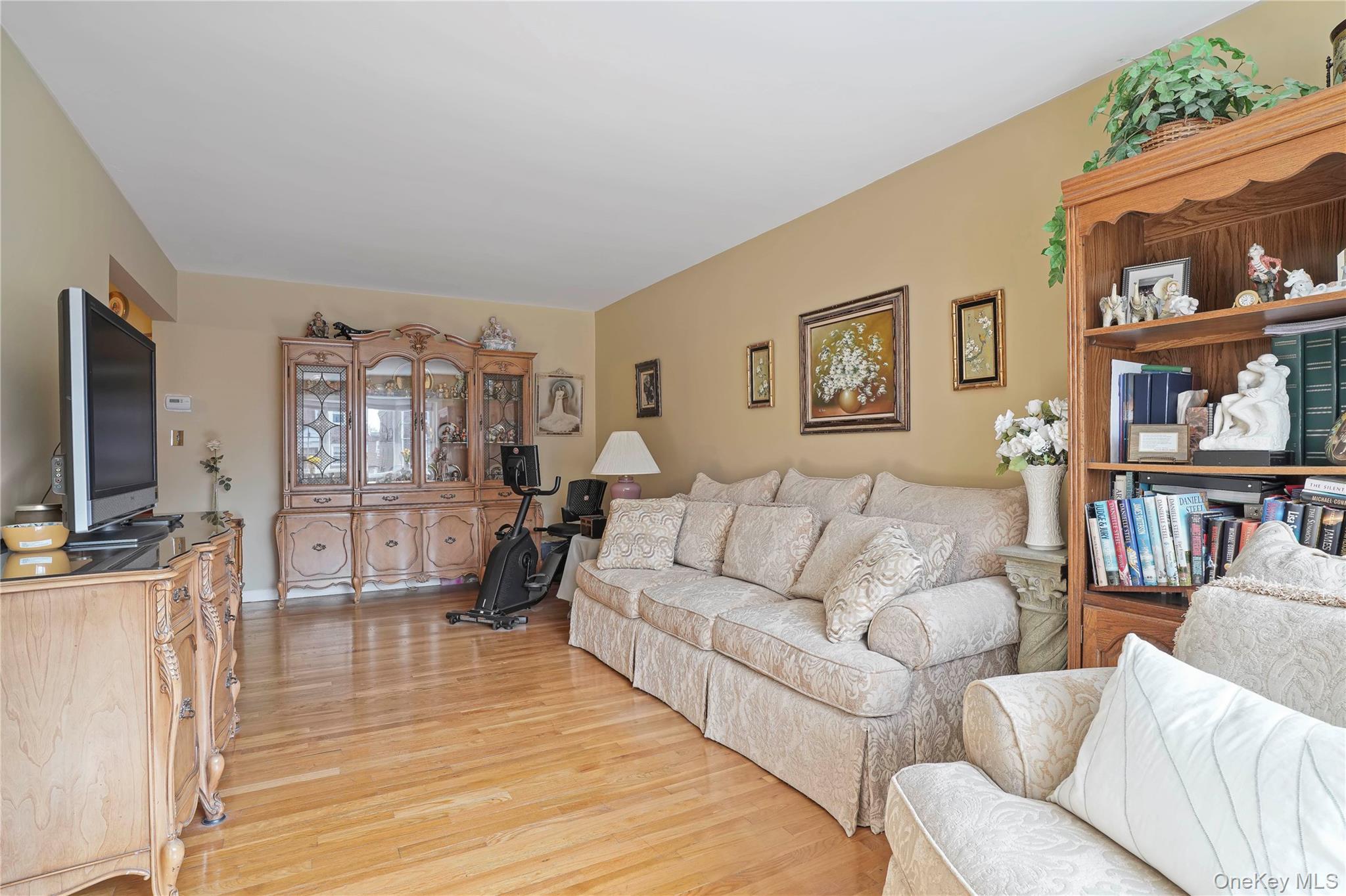 60-35 75th Street Queens, NY 11379 - Photo 12 of 29 a living room with furniture wooden floor and a flat screen tv
