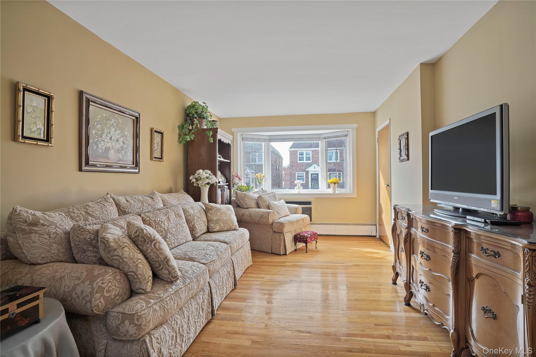 60-35 75th Street Queens, NY 11379 - Photo 14 of 29 a living room with furniture and a flat screen tv