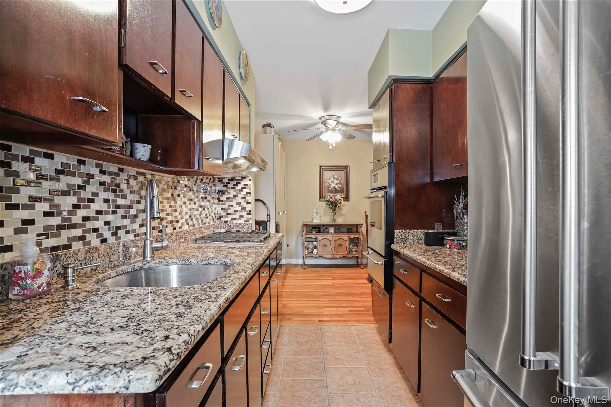 60-35 75th Street Queens, NY 11379 - Photo 17 of 29 a kitchen with counter top space a sink and appliances