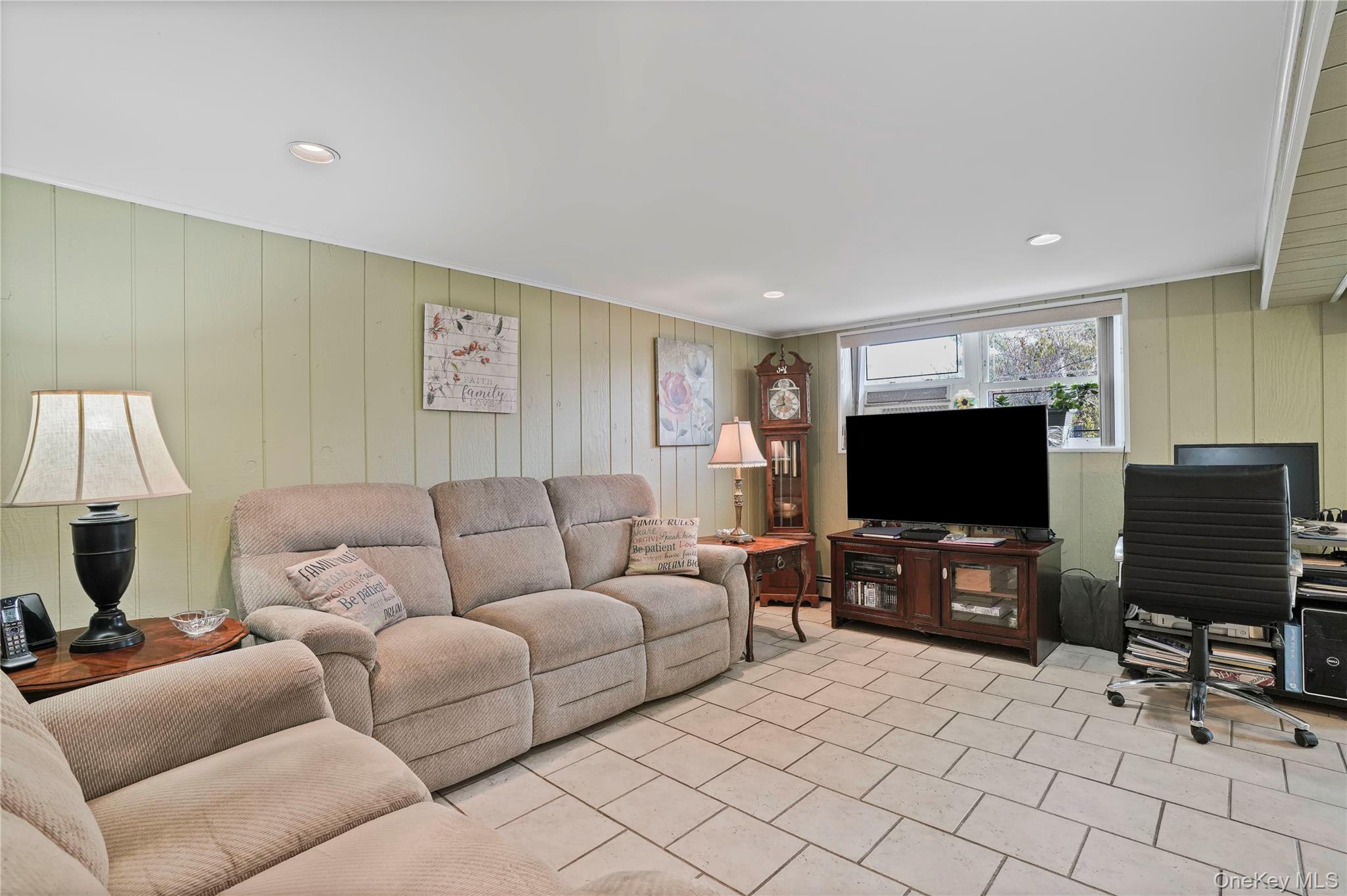60-35 75th Street Queens, NY 11379 - Photo 2 of 29 a living room with furniture and a flat screen tv