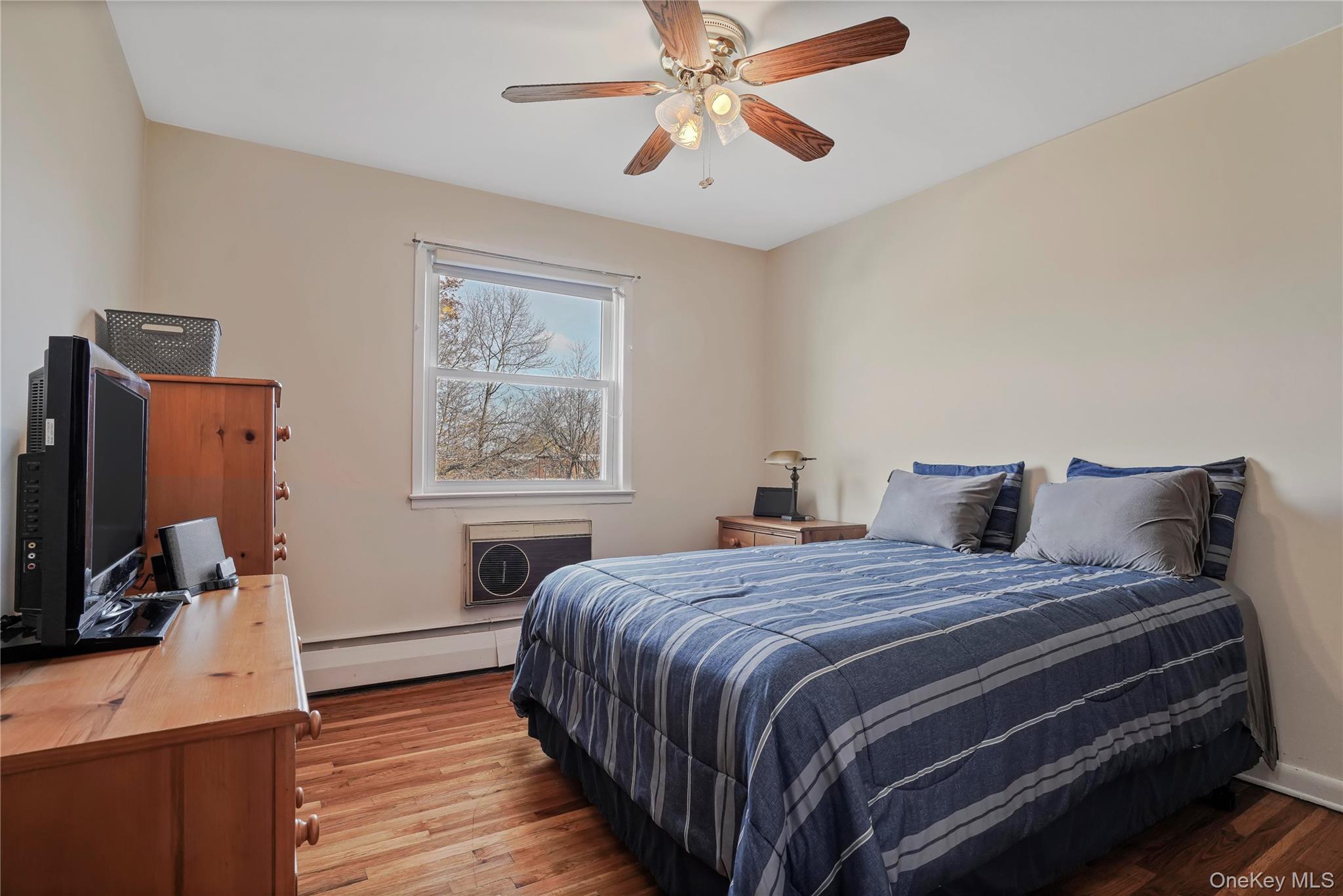 60-35 75th Street Queens, NY 11379 - Photo 22 of 29 a bedroom with a bed and a flat screen tv