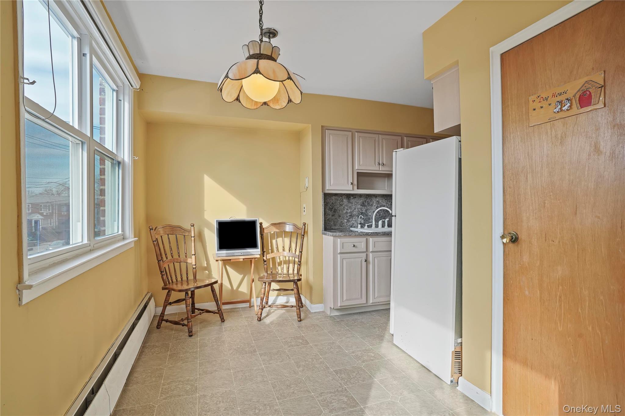 60-35 75th Street Queens, NY 11379 - Photo 23 of 29 a view of kitchen with furniture and a refrigerator