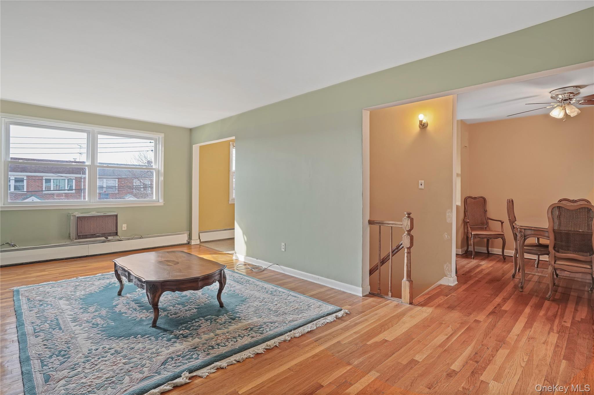 60-35 75th Street Queens, NY 11379 - Photo 24 of 29 a living room with furniture and a wooden floor