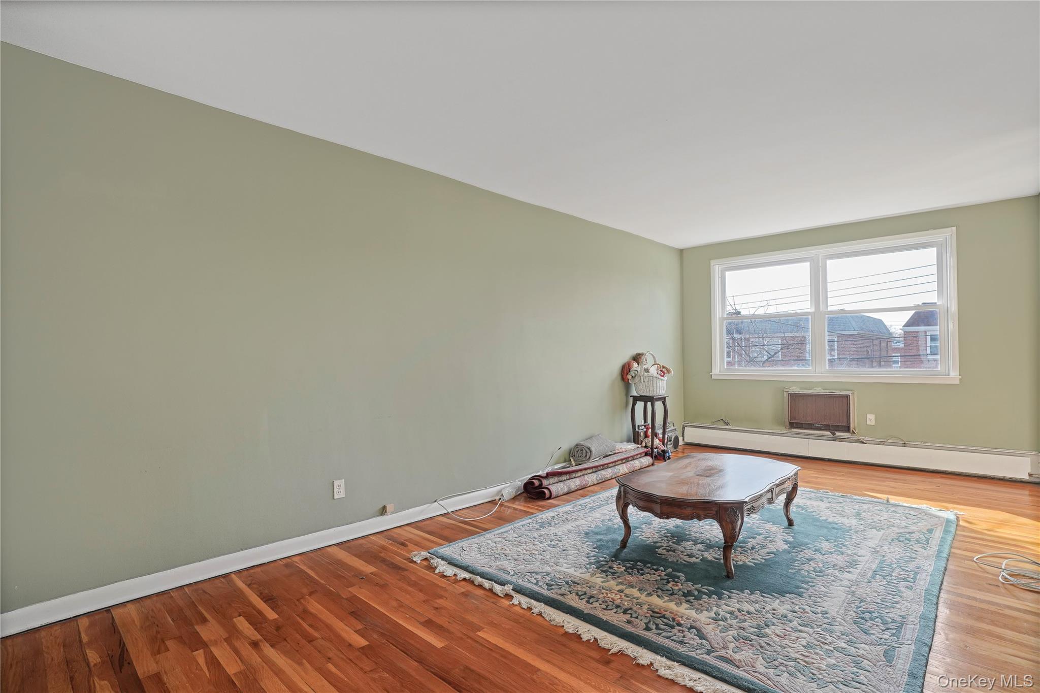 60-35 75th Street Queens, NY 11379 - Photo 25 of 29 a living room with furniture and a window