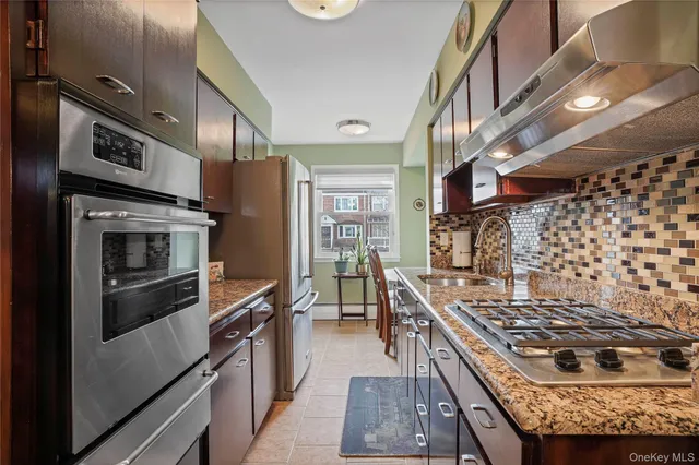 a kitchen with stainless steel appliances granite countertop a stove and a refrigerator
