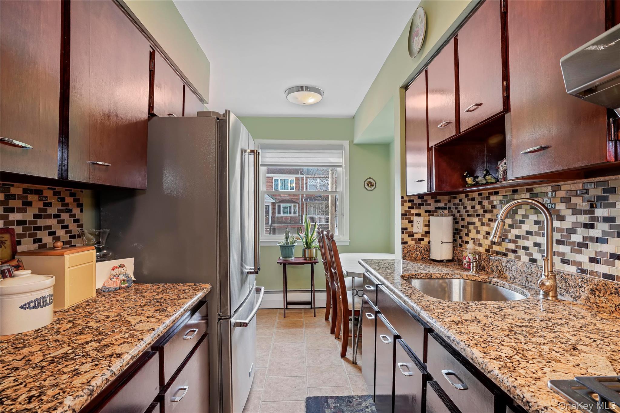 60-35 75th Street Queens, NY 11379 - Photo 8 of 29 a kitchen with stainless steel appliances granite countertop a sink stove and refrigerator