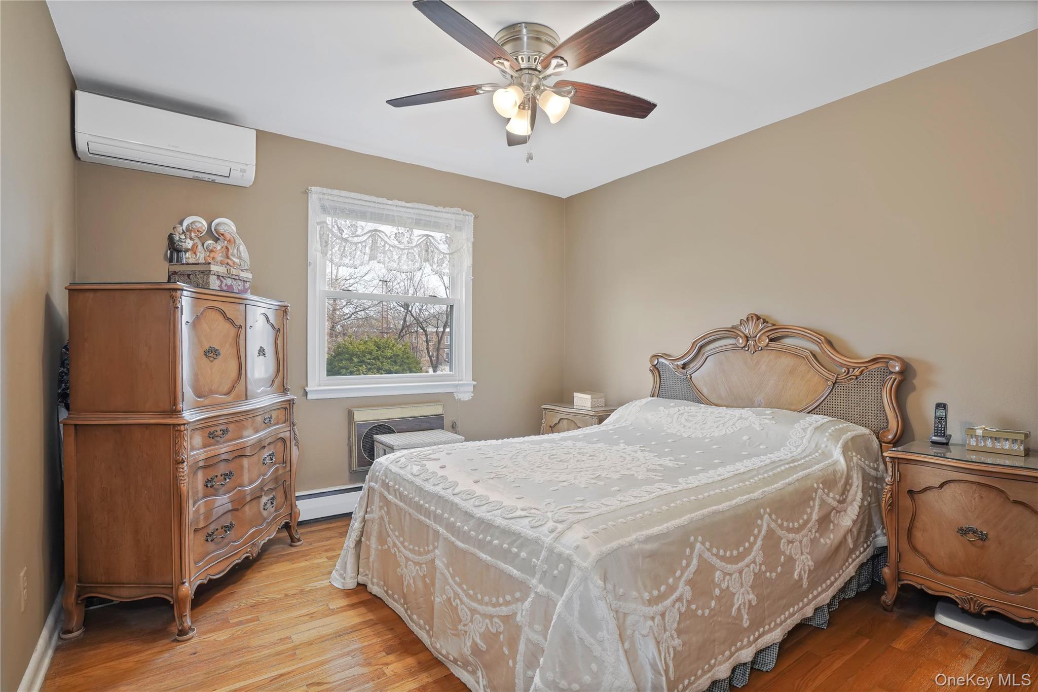 60-35 75th Street Queens, NY 11379 - Photo 10 of 29 a bedroom with a bed and a window