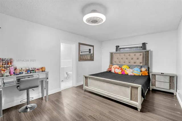 a bedroom with furniture and a wooden floor