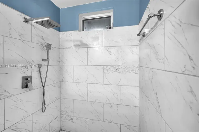 a bathroom with a white shower and vanity