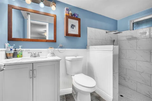 a bathroom with a toilet sink and mirror