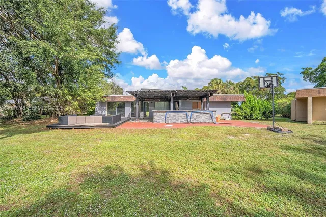 a view of a house with swimming pool and sitting area