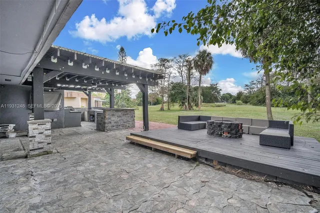 a view of a house with a yard balcony and tree s