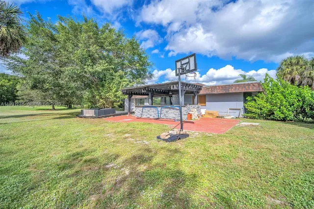 a view of a garden with lawn chairs