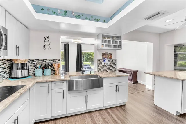 a kitchen with stainless steel appliances granite countertop a sink and cabinets