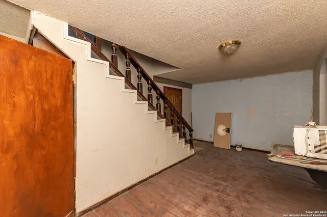 a room with gym equipment and white walls