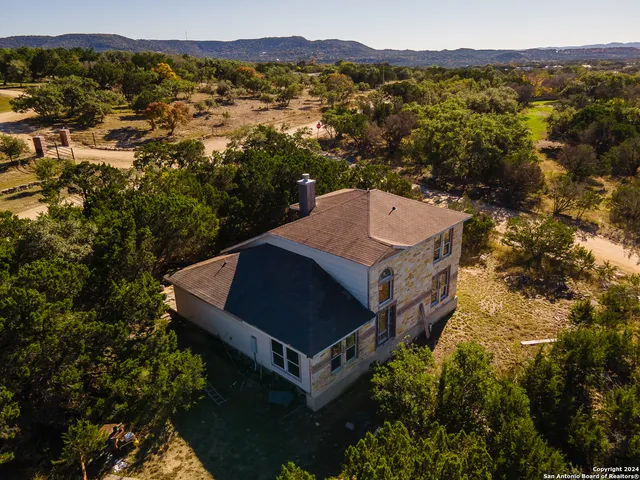 a view of a room with furniture and a window