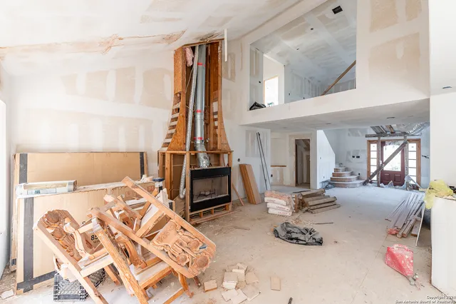 an aerial view of residential houses with city and green space