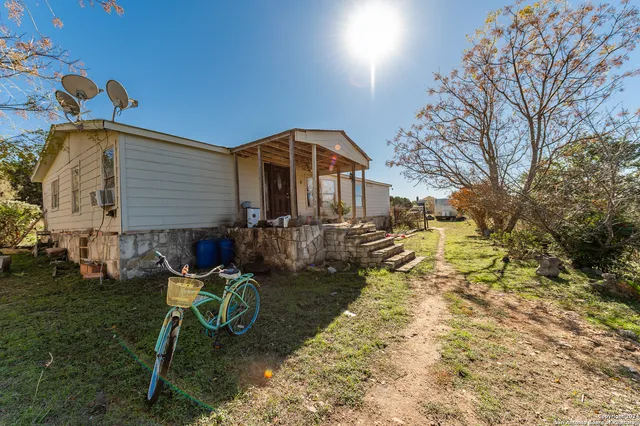a living room with furniture a large window and wooden floor