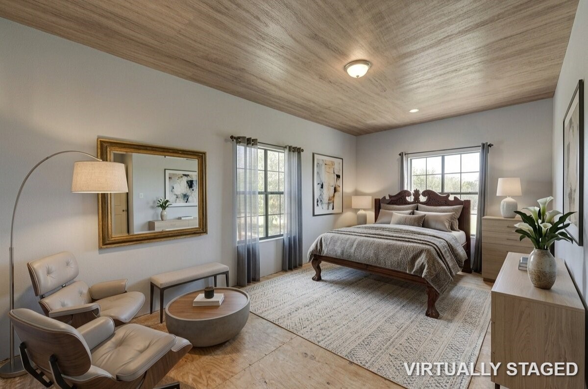 8570 Sunny Side Road Hempstead, TX 77445 - Photo 24 of 48 a spacious bedroom with a bed a couch and potted plant on the dresser