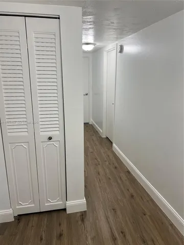 a view of a room with wooden floor