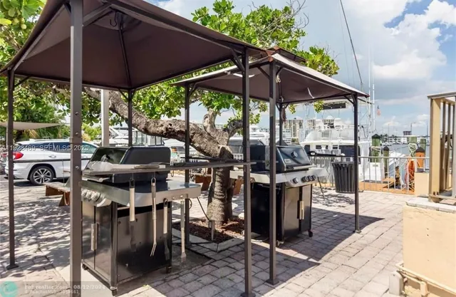 a view of a patio with table and chairs under an umbrella