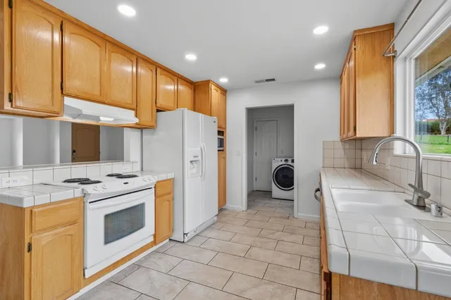 a kitchen with a stove a refrigerator and a sink
