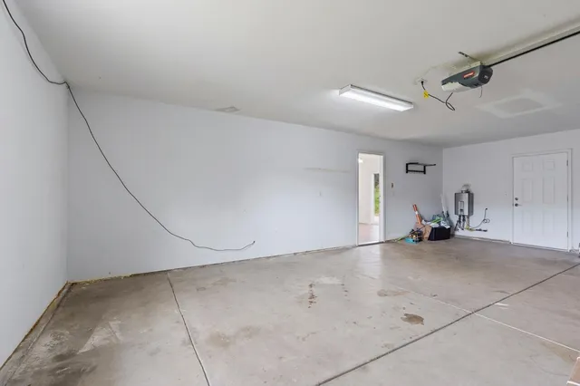 a view of a house with a yard and palm trees