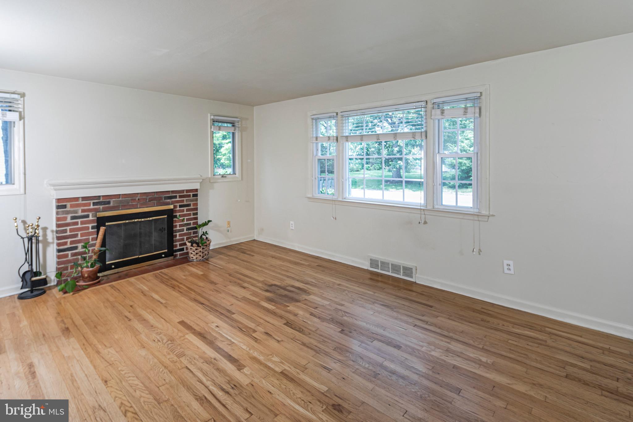 15 Hillside Road Princeton, NJ 08540 - Photo 4 of 30 an empty room with wooden floor fireplace and windows