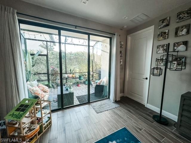7537 Carnegie Way Naples, FL 34119 - Photo 12 of 35 a living room with furniture and a large window