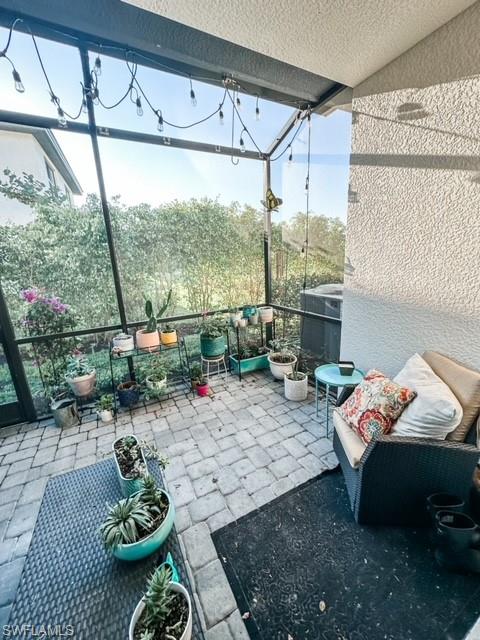 7537 Carnegie Way Naples, FL 34119 - Photo 13 of 35 a living room with furniture and a floor to ceiling window