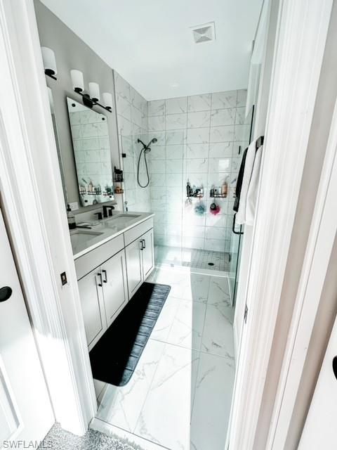 7537 Carnegie Way Naples, FL 34119 - Photo 18 of 35 a bathroom with double vanity sink and mirror