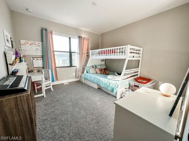 7537 Carnegie Way Naples, FL 34119 - Photo 19 of 35 a living room with furniture and a flat screen tv