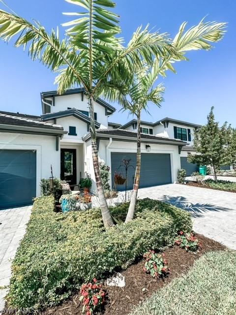 7537 Carnegie Way Naples, FL 34119 - Photo 2 of 35 a front view of a house with a yard