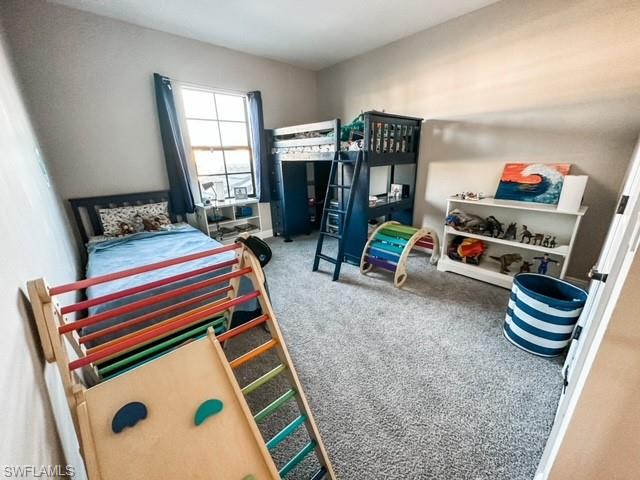 7537 Carnegie Way Naples, FL 34119 - Photo 26 of 35 a living room with furniture a flat screen tv and a table