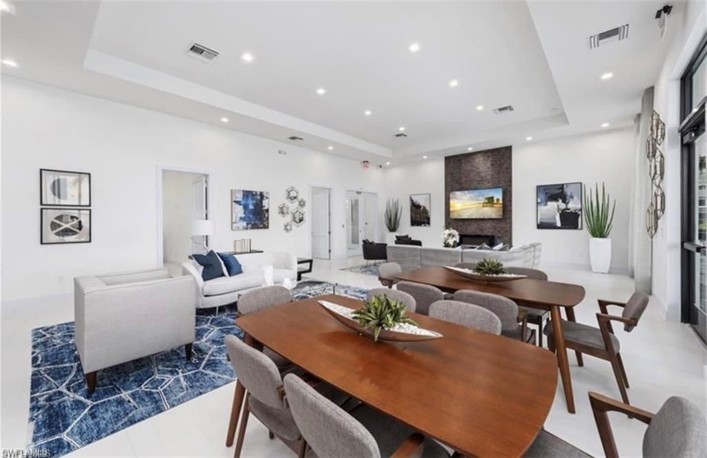 7537 Carnegie Way Naples, FL 34119 - Photo 35 of 35 a living room with furniture kitchen view and a flat screen tv